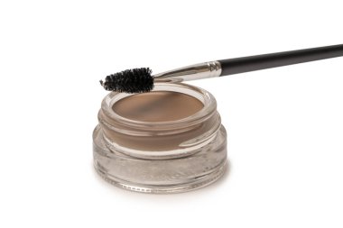 A brow pomade in blonde shade with brush isolated on a white background. Make up. 