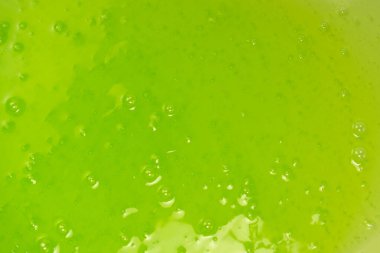 Arka plan olarak yeşil balçık oyuncağı. Üst görünüm. 