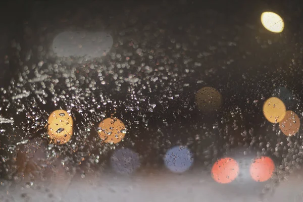 stock image Blurred background with raindrops and lights.