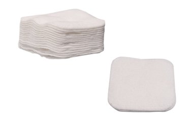 Stack of white cotton sponges isolated on a white background.