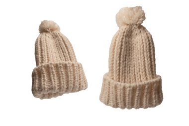 Beige warm beanie hat with pom pom isolated on a white background. 