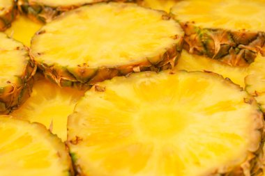 Arka plan olarak ananas sulu sarı dilimler. Üst görünüm.