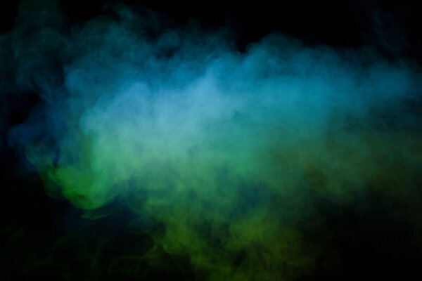 Green and white steam on a black background. Copy space.