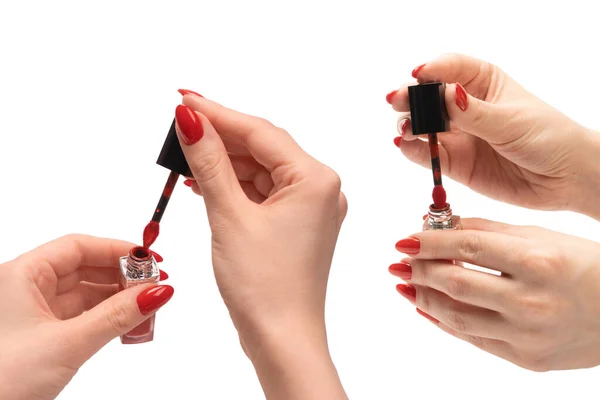 Red liquid lipstick in woman hands with red nails isolated on a white background. Copy space.