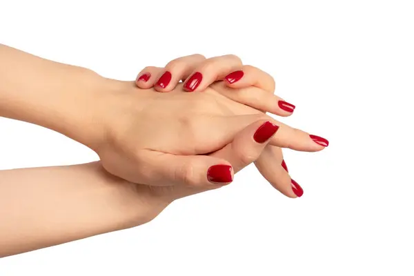 白い背景に隔離されたワインの赤い爪を持つ女性の手 赤いネイルポーランド語 スクエアネイルフォーム ロイヤリティフリーのストック画像