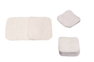 Stack of white cotton sponges isolated on a white background.