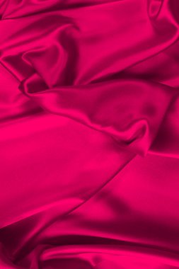 Kırmızı ipek ya da saten lüks kumaş dokusu soyut bir arka plan olarak kullanılabilir. Üst görünüm.