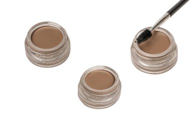 A brow pomade in blonde shade with brush isolated on a white background. Make up. 