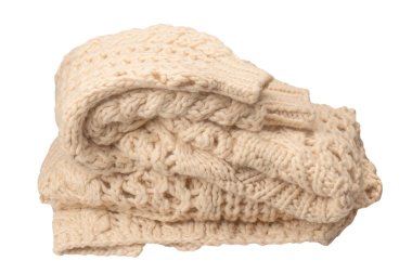 A fragment of beige knitted fabric, knitted from white sheep wool. Knitted background. 