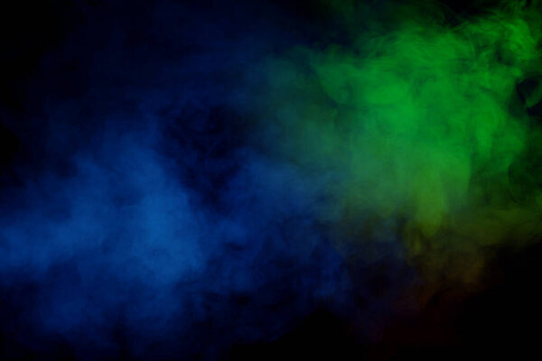 Red and green steam on a black background. Copy space.