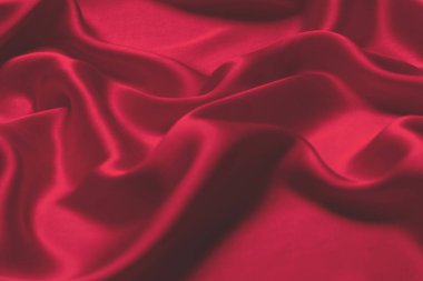Kırmızı ipek ya da saten lüks kumaş dokusu soyut bir arka plan olarak kullanılabilir. Üst görünüm.