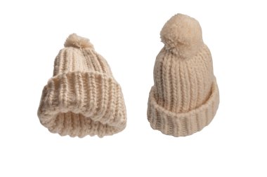 Beige warm beanie hat with pom pom isolated on a white background. 