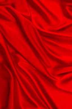 Kırmızı ipek ya da saten lüks kumaş dokusu soyut bir arka plan olarak kullanılabilir. Üst görünüm.