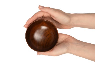 Kadın eli beyaz arka planda izole edilmiş ahşap bir kase tutuyor.. 