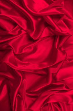 Kırmızı ipek ya da saten lüks kumaş dokusu soyut bir arka plan olarak kullanılabilir. Üst görünüm.
