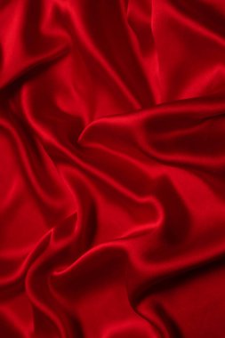Kırmızı ipek ya da saten lüks kumaş dokusu soyut bir arka plan olarak kullanılabilir. Üst görünüm.