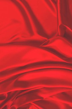 Kırmızı ipek ya da saten lüks kumaş dokusu soyut bir arka plan olarak kullanılabilir. Üst görünüm.