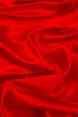Kırmızı ipek ya da saten lüks kumaş dokusu soyut bir arka plan olarak kullanılabilir. Üst görünüm.
