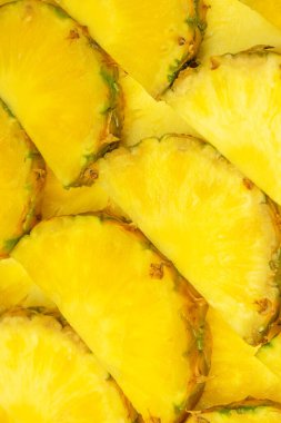 Arka plan olarak ananas sulu sarı dilimler. Üst görünüm.