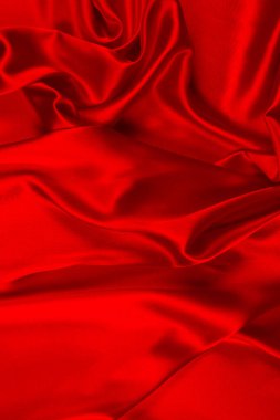 Kırmızı ipek ya da saten lüks kumaş dokusu soyut bir arka plan olarak kullanılabilir. Üst görünüm.