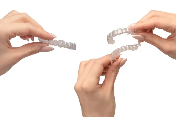 Stock image Transparent mouth guard in a woman's hand isolated on a white background. 