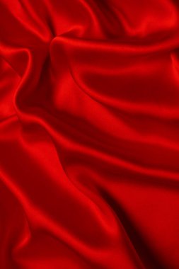 Kırmızı ipek ya da saten lüks kumaş dokusu soyut bir arka plan olarak kullanılabilir. Üst görünüm.
