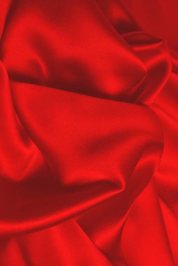 Kırmızı ipek ya da saten lüks kumaş dokusu soyut bir arka plan olarak kullanılabilir. Üst görünüm.