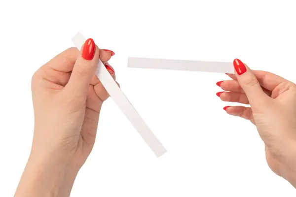 stock image Woman hand with red nails with test strips for the perfume, isolated on a white background. Perfume blotters.