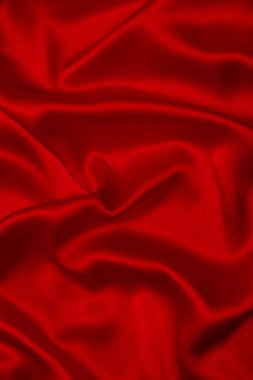 Kırmızı ipek ya da saten lüks kumaş dokusu soyut bir arka plan olarak kullanılabilir. Üst görünüm.