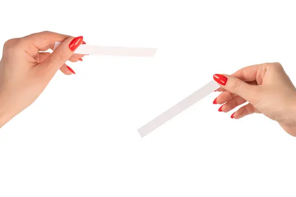 stock image Woman hand with red nails with test strips for the perfume, isolated on a white background. Perfume blotters.