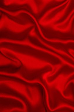 Kırmızı ipek ya da saten lüks kumaş dokusu soyut bir arka plan olarak kullanılabilir. Üst görünüm.
