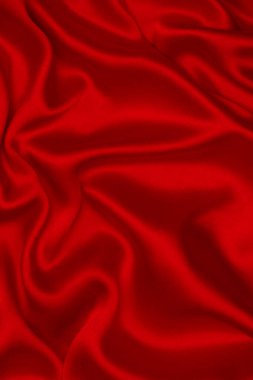 Kırmızı ipek ya da saten lüks kumaş dokusu soyut bir arka plan olarak kullanılabilir. Üst görünüm.