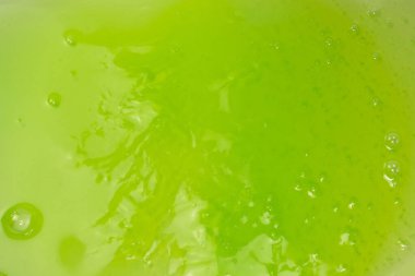 Arka plan olarak yeşil balçık oyuncağı. Üst görünüm. 