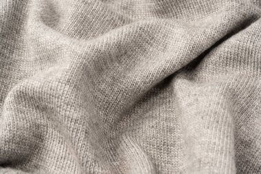 Arka plan olarak gri yün süveter dokusu. Üst görünüm.