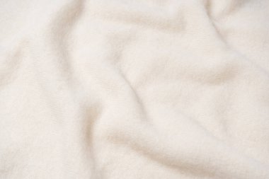 Arka plan olarak bej süveter dokusu. Üst görünüm. 