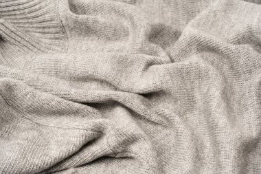 Arka plan olarak gri yün süveter dokusu. Üst görünüm.