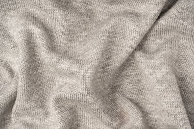 Arka plan olarak gri yün süveter dokusu. Üst görünüm.