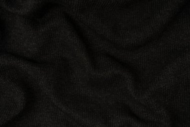 Arka plan olarak koyu gri süveter dokusu. Örgü desenli. Üst görünüm. 