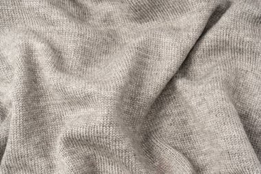 Arka plan olarak gri yün süveter dokusu. Üst görünüm.