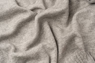 Arka plan olarak gri yün süveter dokusu. Üst görünüm.