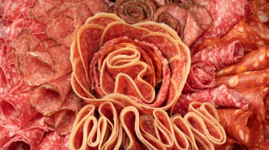 Tahtada farklı et parçaları var. Siyah bir arkaplanda.