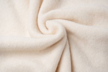 Arka plan olarak bej süveter dokusu. Üst görünüm. 