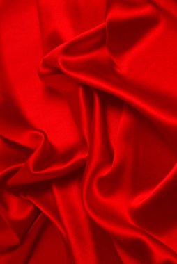 Kırmızı ipek ya da saten lüks kumaş dokusu soyut bir arka plan olarak kullanılabilir. Üst görünüm.