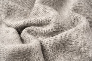 Arka plan olarak gri yün süveter dokusu. Üst görünüm.