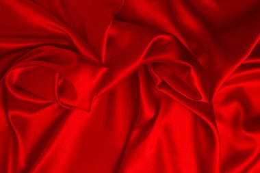 Kırmızı ipek ya da saten lüks kumaş dokusu soyut bir arka plan olarak kullanılabilir. Üst görünüm.