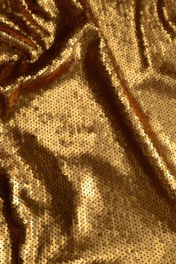 Altın payetler kumaş doku. Üstte görüntü.