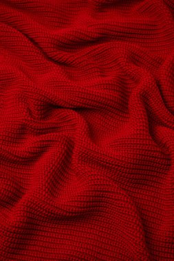 Arka plan olarak kırmızı süveter dokusu. Üst görünüm