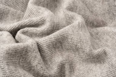 Arka plan olarak gri yün süveter dokusu. Üst görünüm.