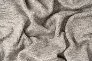 Arka plan olarak gri yün süveter dokusu. Üst görünüm.