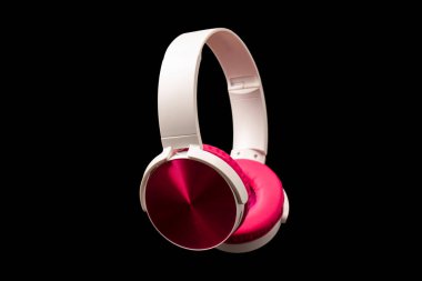 Siyah arkaplanda pembe ve beyaz kulaklıklar var.. 